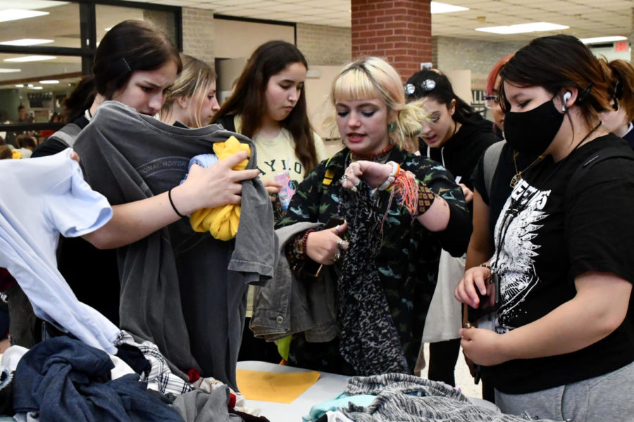 Surrounded by friends and classmates, Gracey Laboy-Lopez looks for clothes.