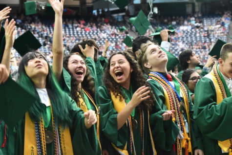 Kate Hargrave, Emily Bernal, Andrea Cardona Sanchez and Michael Kell watch their hats fly at the end of their graduation ceremony at NRG Stadium on May 27. 