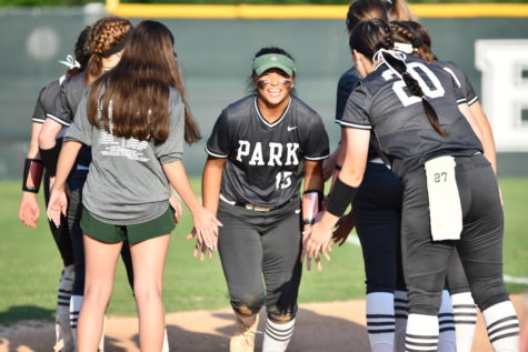 Senior Taysia Constantino runs to the field through a tunnel of teammates during pregame introductions.