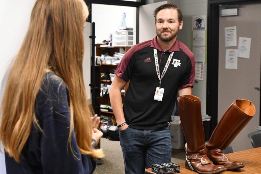 History+teacher+Eric+Coovert+talks+in+May+of+2022+about+his+time+at+Texas+A%26M+while+showing+off+his+boots+he+wore+his+senior+year+as+a+part+of+the+Corps+of+Cadets.+He+was+a+drummer+in+the+Aggie+band.