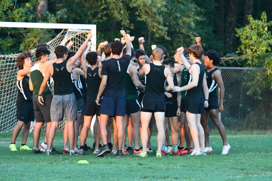 The boys varsity cross country team does a quick huddle before starting their race on Aug. 18 at Atascocita High School. 