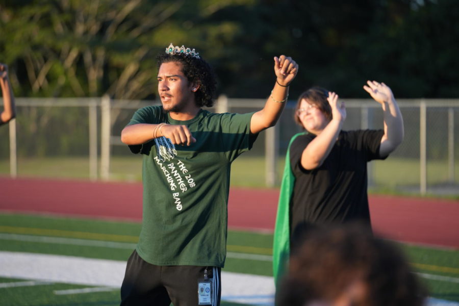 New color guard coach Esber Ramos works with his group at the outdoor homecoming pep rally.