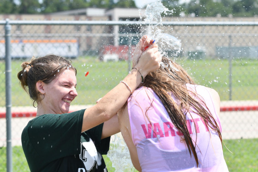 Junior Sophie-Clark Merkle splatters a water balloon over a fellow cheerleader on Sept. 10 at the Panther Pals Back To School Bash after the cheer team showed up and showed out in support of the event.