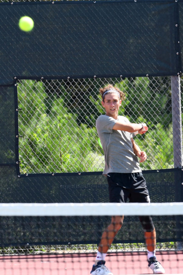 Senior Sean Helton hits a forehand shot against Nacogdoches during his singles match. 