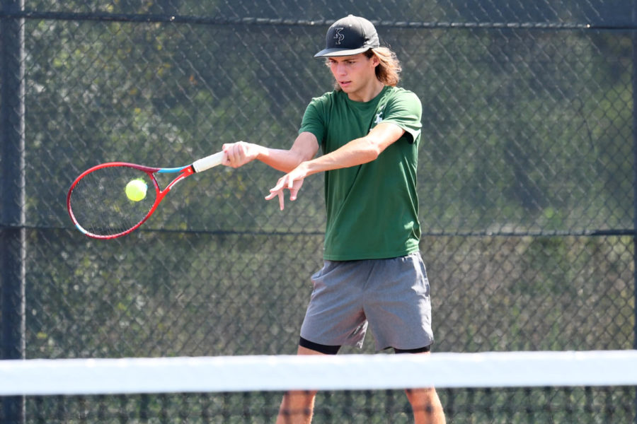 Jacob Reding returns a forehand during a match against Nacogdoches. He started playing tennis last year.