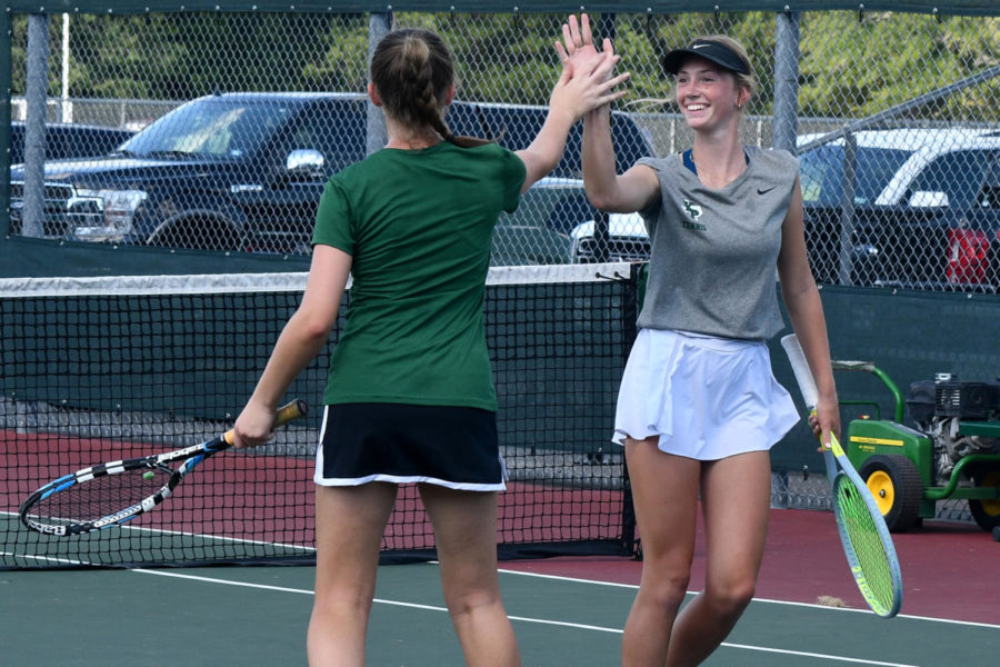 Junior Brooke OBrien and senior Pippi Timpanaro celebrate a point during their doubles match against Nacogdoches earlier this season.