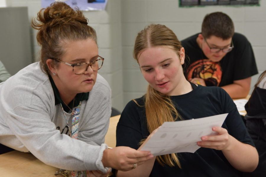 Forensic science teacher Tonya Johnston talks with senior Meagan Heise during 7th period as the students worked on a fingerprint project. 
