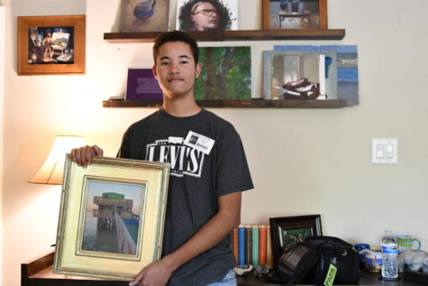 Sophomore Brian Beckford holds a picture he painted. He took up painting during COVID.