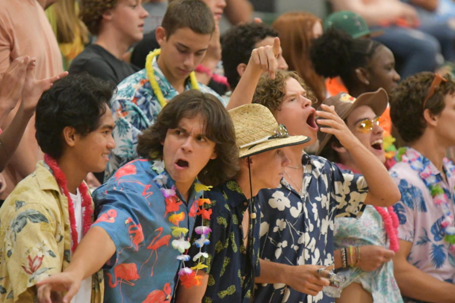 Senior Hunter Keelen helps lead the student section on Hawaiian Night at the New Caney volleyball game on Aug. 10. 