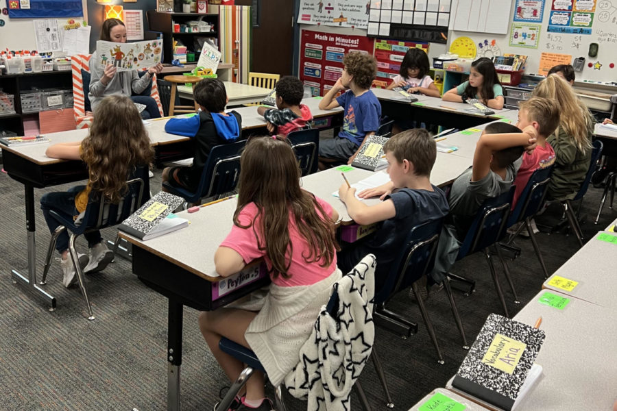 Junior Parker Wardlow reads to students at Woodland Hills Elementary during her teacher internship program.