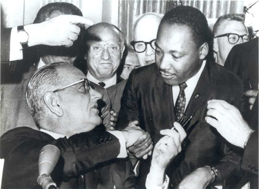 President+Lyndon+Johnson+shakes+hands+with+the+Reverend+Martin+Luther+King%2C+Jr.%2C+after+handing+him+one+of+the+pens+used+in+signing+the+Civil+Rights+Act+of+July+2%2C+1964+at+the+White+House+in+Washington.