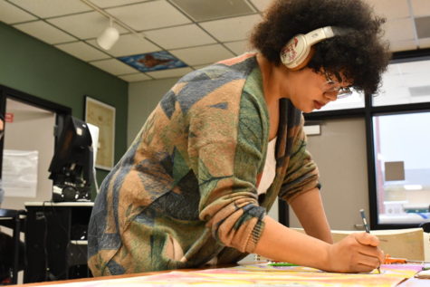 Senior Grace Blessing works on a piece of art during class in November.