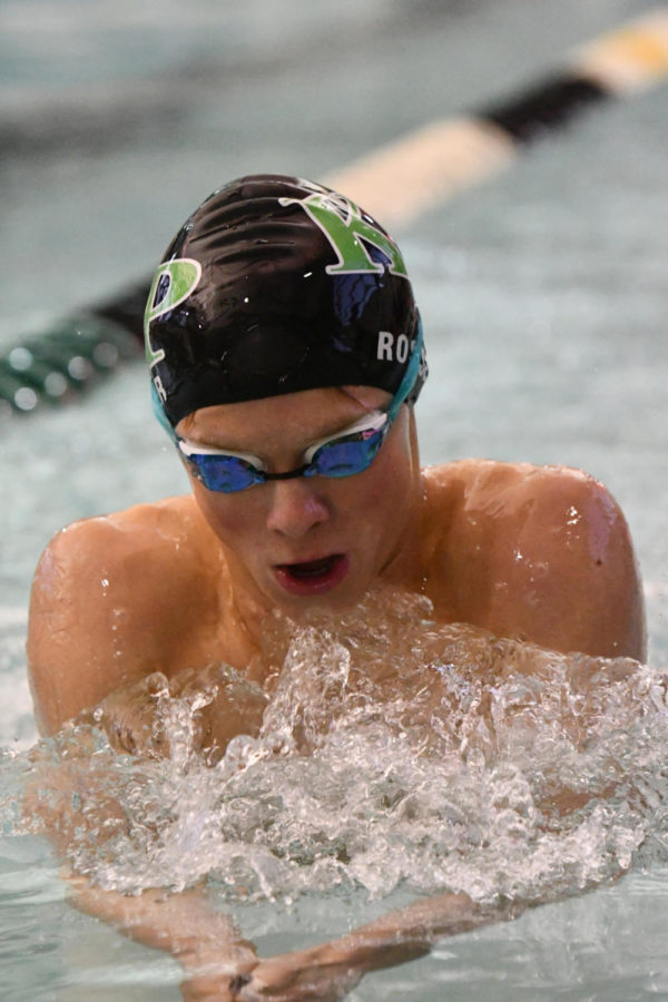 Junior Logen Black competes in the breaststroke on Jan. 6 in the final home meet. He is one of nine swimmers who qualified for the State Meet.
