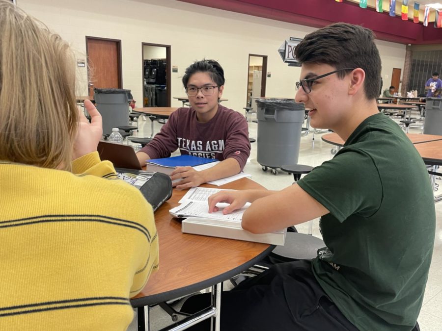 While waiting for their next computer science event, juniors Vuong Nguyen and Max Leal talk with junior David Geslison, They took second place as a team.