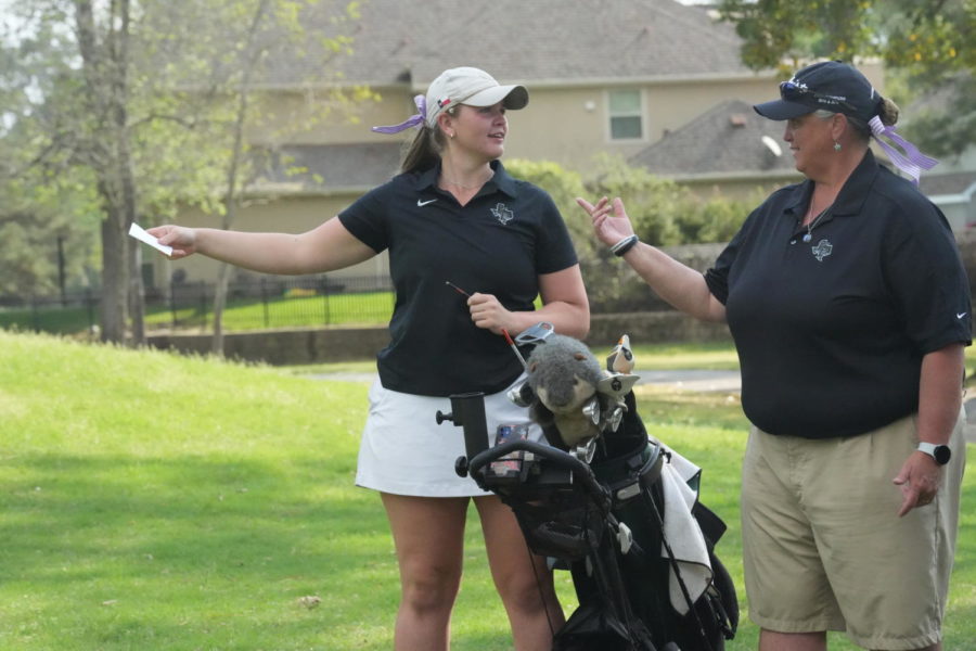Sophomore Daniel Daniel talks with coach Angela Chancellor during a tournament at Kingwood Country Club in March. 