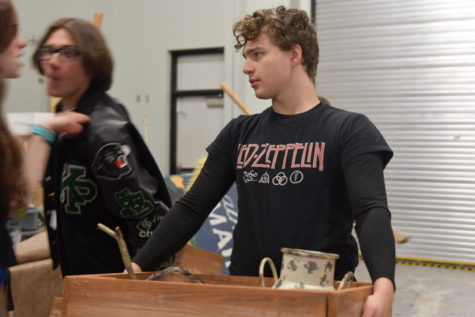 Senior Cameron Williams helps move set pieces for their UIL show “The Diviners.” The cast placed third in the district competition and advanced for bi-districts on March 23. 