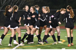 The girls soccer team celebrates after a goal against Huntsville in February. They enter the postseason, 18-1-1. 