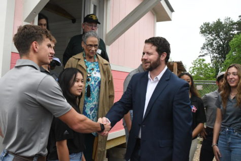 After touring the latest Tiny Home being built by the architecture students, congressman Dan Crenshaw shakes hands with senior Jonathan Mitchell. Mitchell is a captain on this years Tiny Home team. Crenshaw spoke to students about the importance of their project. 