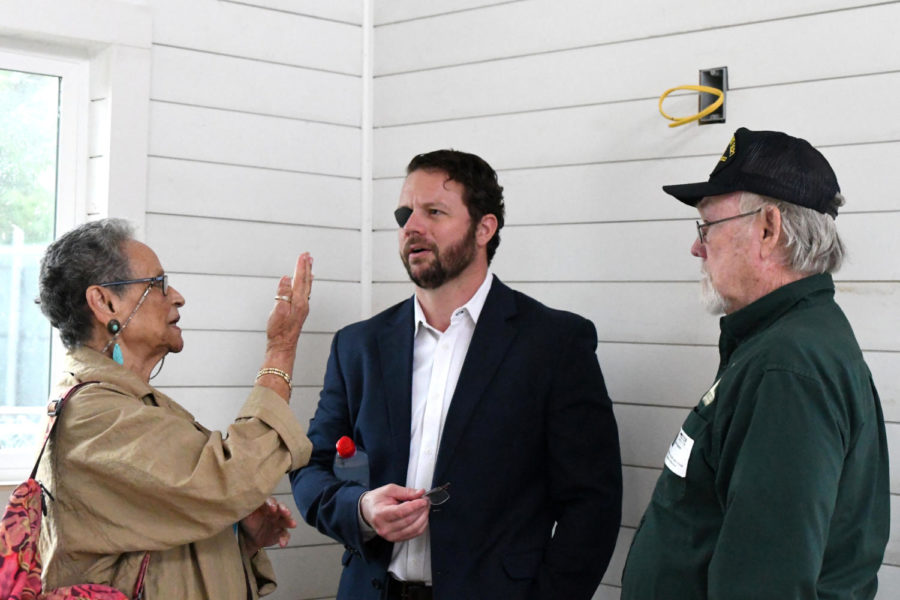 Barbara Lange, the founder of the Langetree Tiny Houses Project, speaks with congressman Dan Crenshaw and Mark Bowen, who is the board president on the Langetree project.