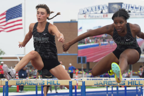 Seniors Lindsay Collins and Stalyce Green clear the hurdles during the 100 meter hurdles.