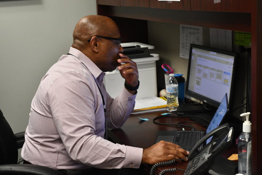 Assistant principal Mack Malone works on his computer during a break in the day. 