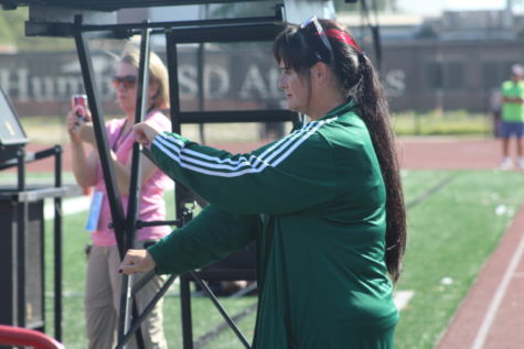 Band Director Bre Osbourn steps on the podium during marching band rehearsal.