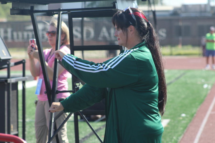 Band Director Bre Osbourn steps on the podium during marching band rehearsal.