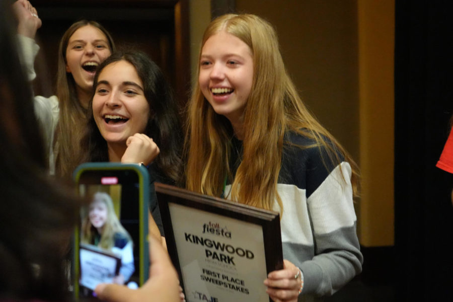 Senior Katie Gerbasich clutches the Sweepstakes prize at the high school state journalism conference in October as junior Kara OHara and sophomore Kaitlyn Sitton celebrate.