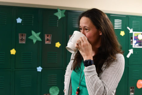 English teacher Kimberly Villegas drinks coffee in the hallway between classes. 