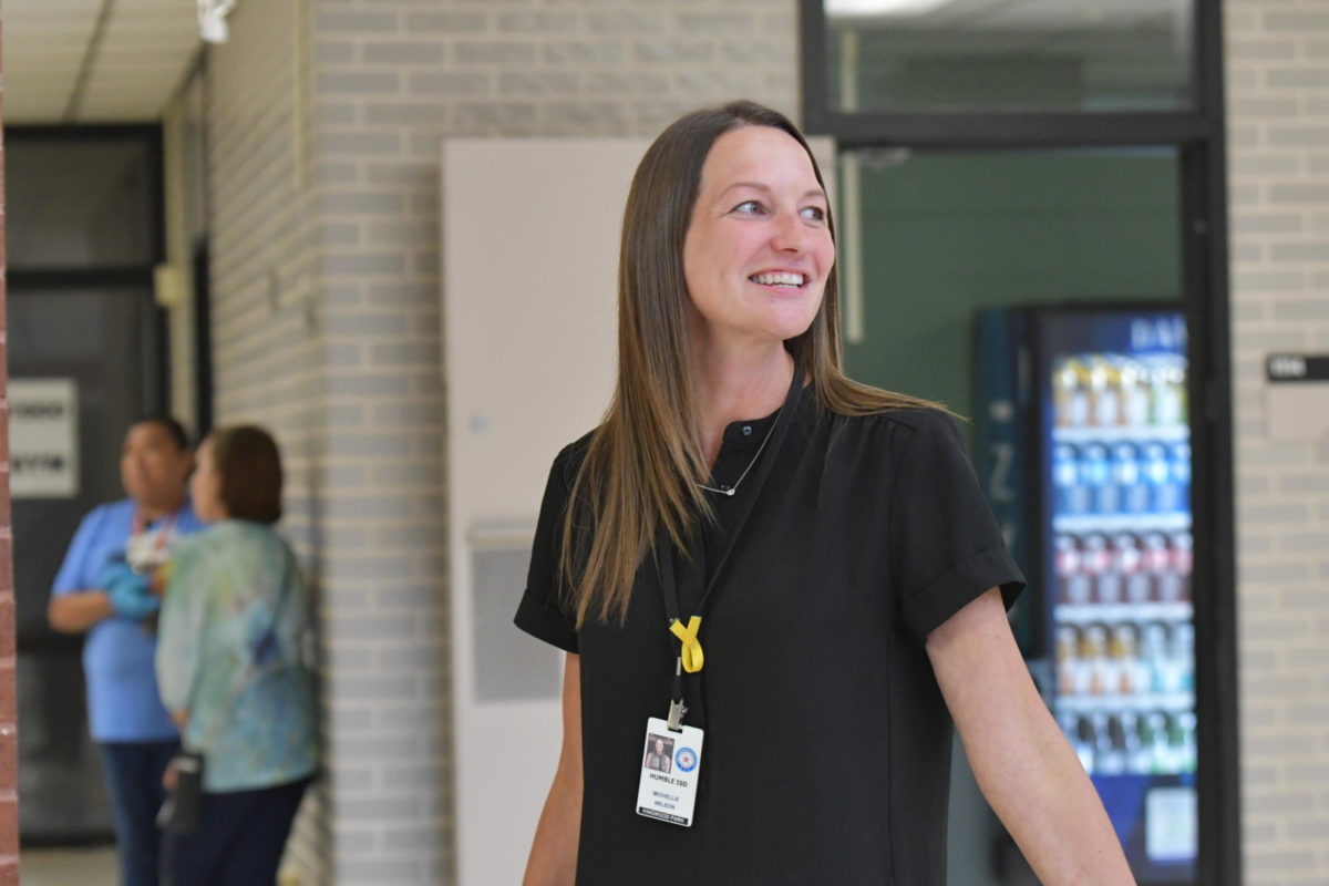 Assistant Principal Michelle Wilson smiles at a student while on lunch duty.