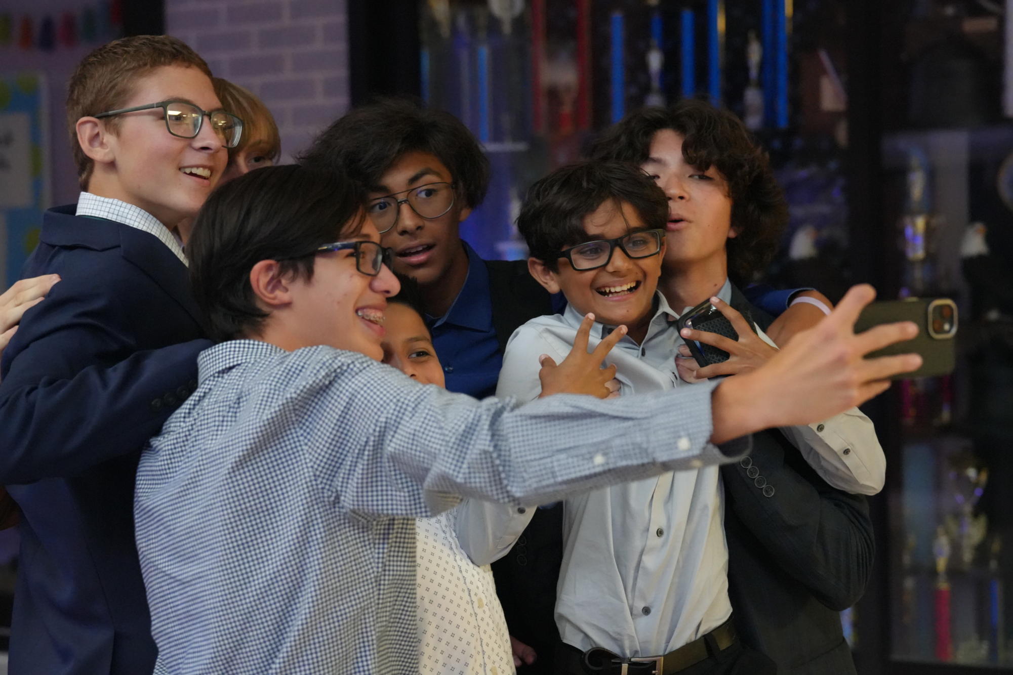A group of friends cram together to fit in a selfie during the homecoming dance on Sept. 9. 