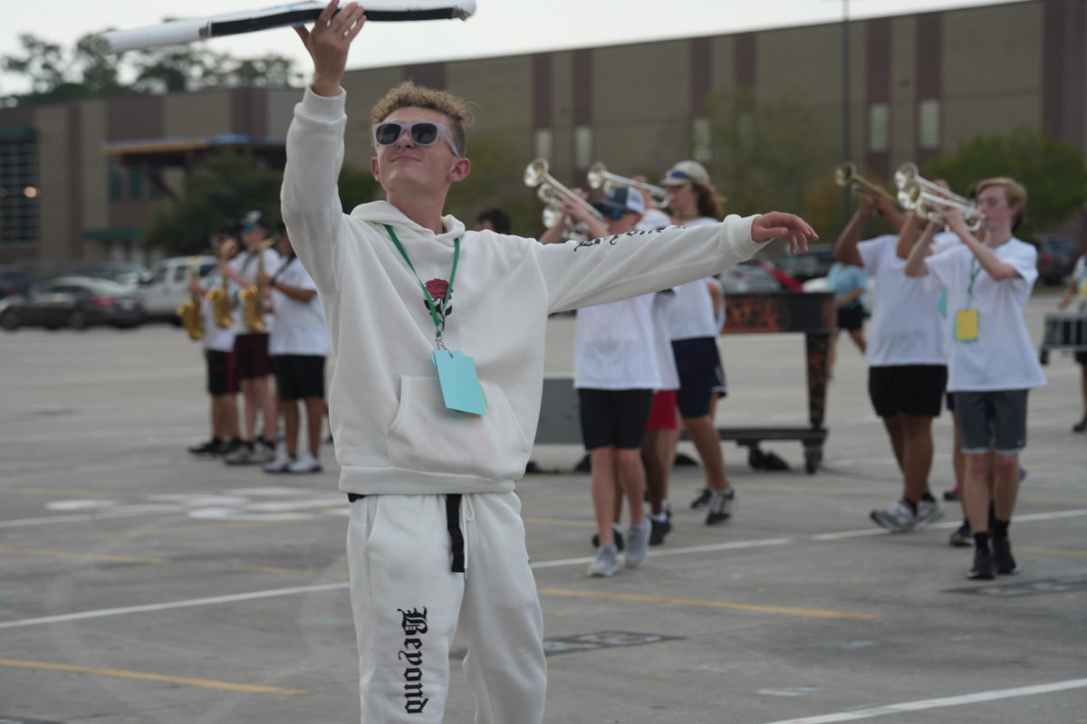 Sophomore+Ean+Osbourn+practices+with+the+band+on+the+school+parking+lot.+He+spent+much+of+his+summer+with+the+Iowa+Colts%2C+where+he+traveled+and+performed+with+the+groups+color+guard.