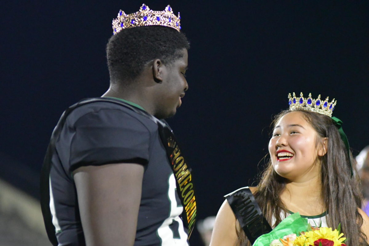 Seniors+Bobby+West+and+Alani+Martinez+meet+up+at+the+center+of+the+football+field+after+being+crowned+homecoming+king+and+queen.+