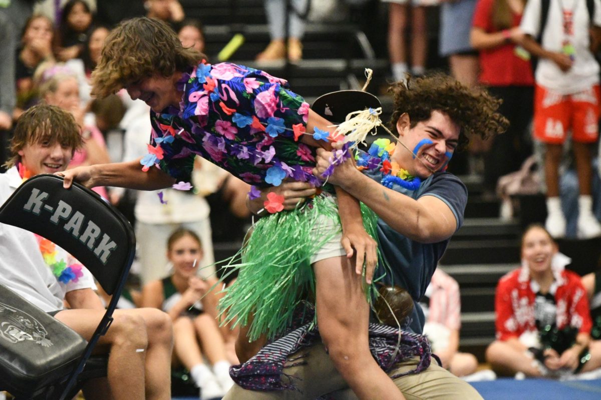 David Gonzalez, 11, yanks Luca Gagliardi, 9, off a chair to secure his spot in an aggresive game of musical chairs during the Hawaiian themed pep rally of the year on Aug. 25.
