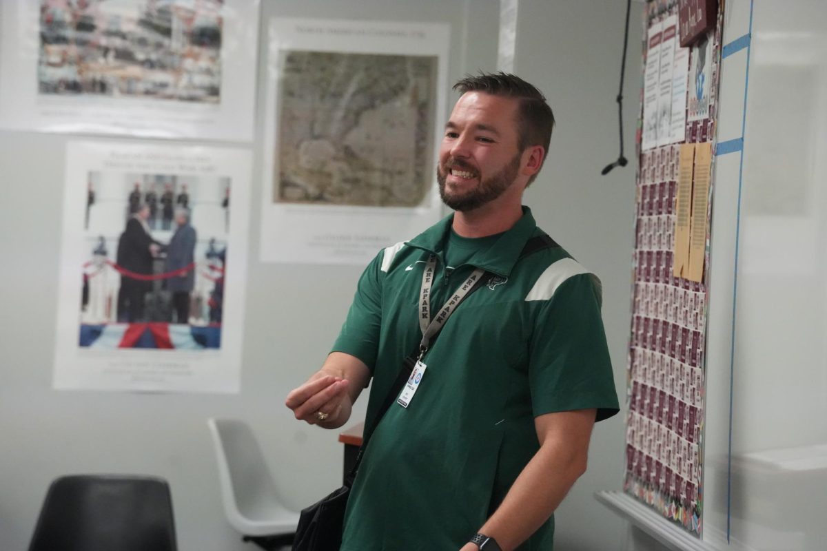 History teacher Eric Coovert tries to keep the mood lighthearted as he tells his first period students about his cancer diagnosis on the first day of school. While he taught that day, he was wearing his chemo as it pumped through a port in his chest.