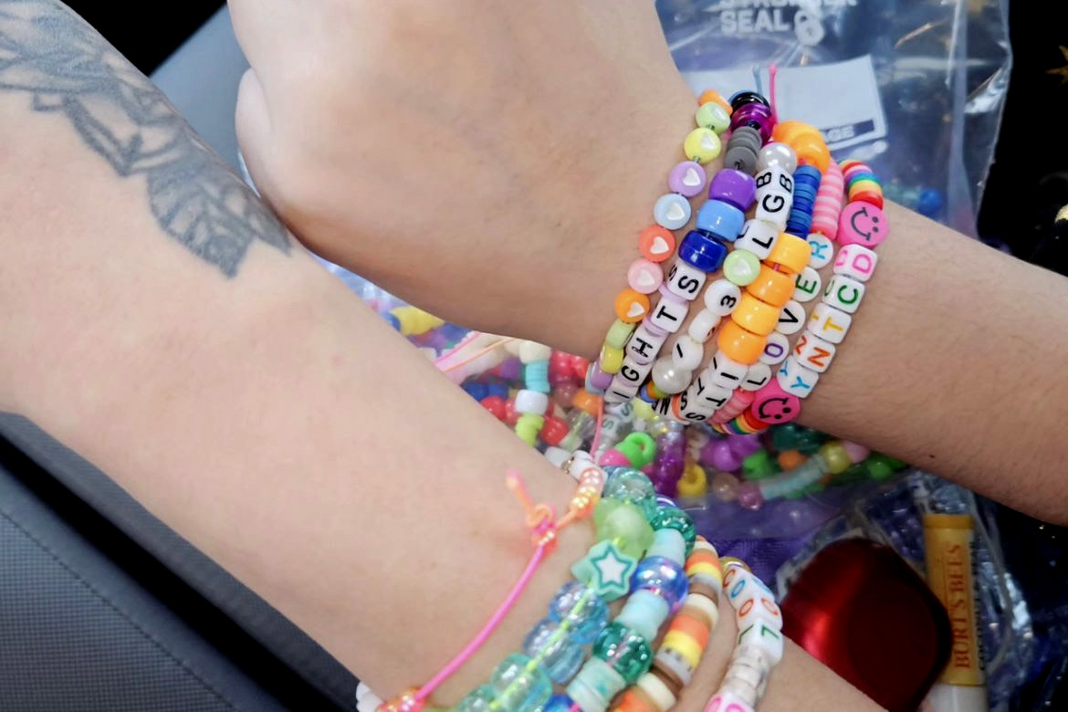 Evelyn Vela-West and her mom show off their bracelets before they go to the Eras Tour concert in April. 