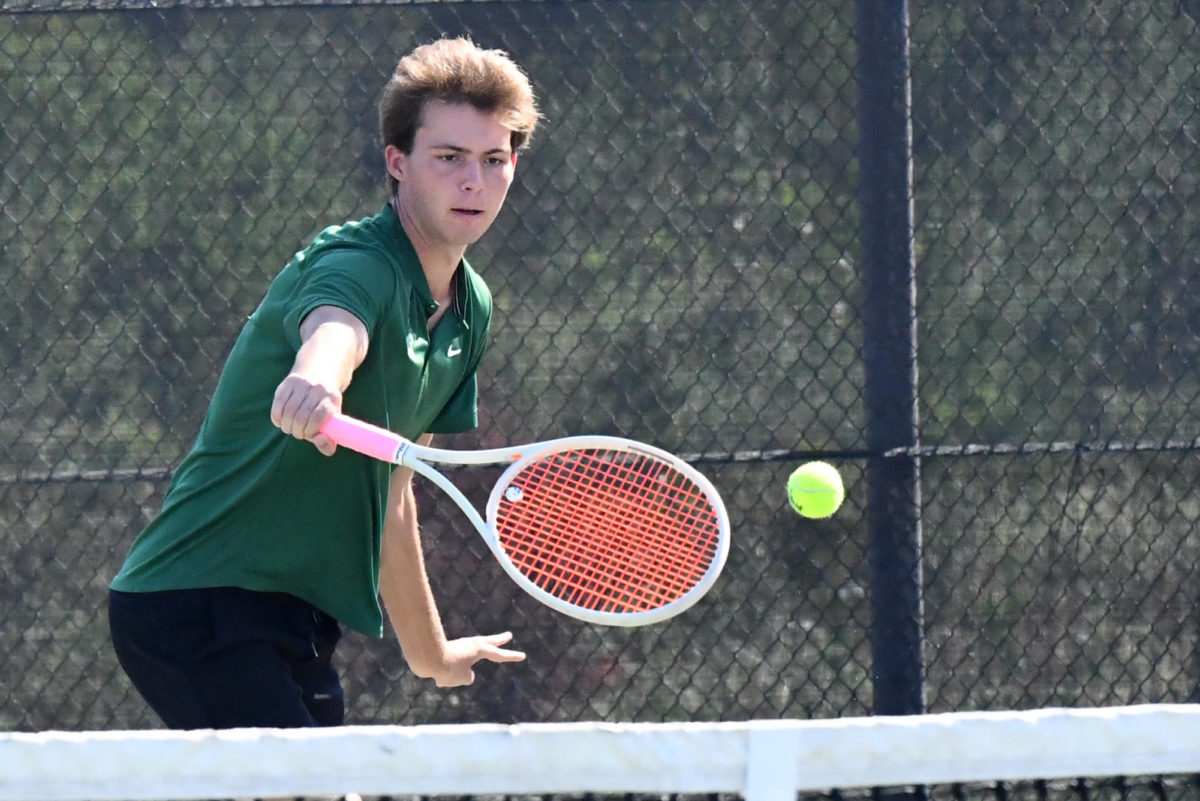 Senior Jacob Reding hits a backhand near the net in a match against Porter in late September. The Panthers finished the regular season with nine-consecutive team wins. 