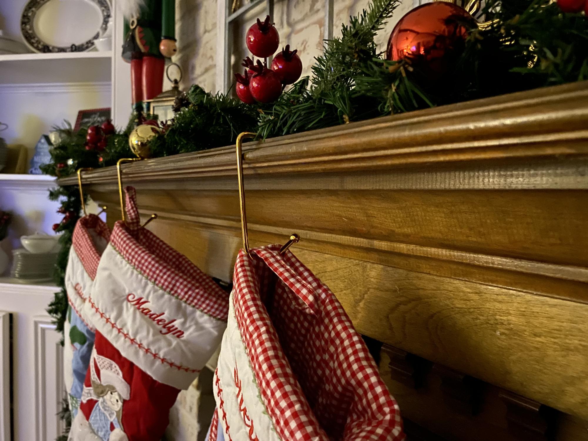 The stockings hang on a mantle as families prepare for the holidays.