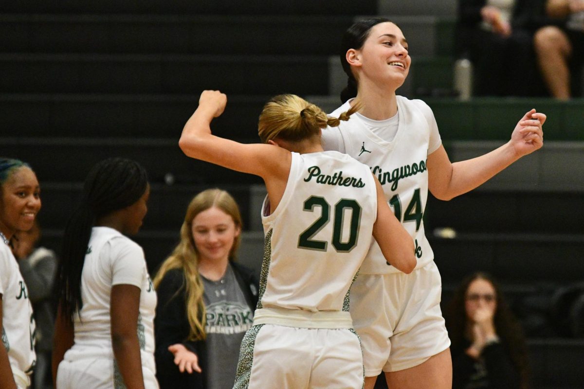 Sophomore Madison Staggs and senior Madi Barker do a shoulder bump for their handshake during player introductions against Magnolia High School.
