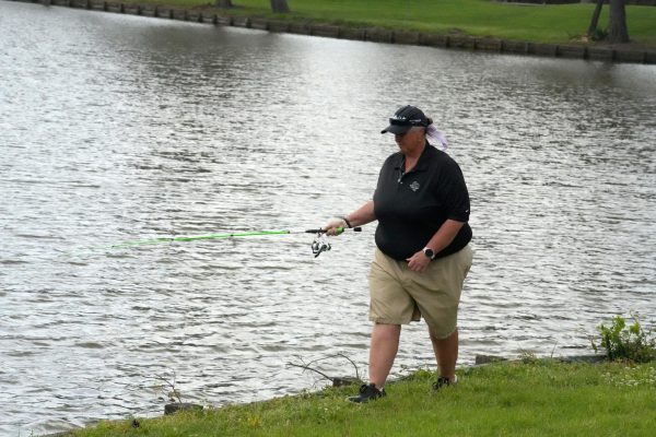 In breaks of action during a spring golf tournament, coach Angela Chancellor threw her portable fishing pole in the ponds on the course.