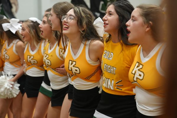 The cheerleaders participate in singing the school fight song at the end of the Gold Fight Win pep rally in September. 