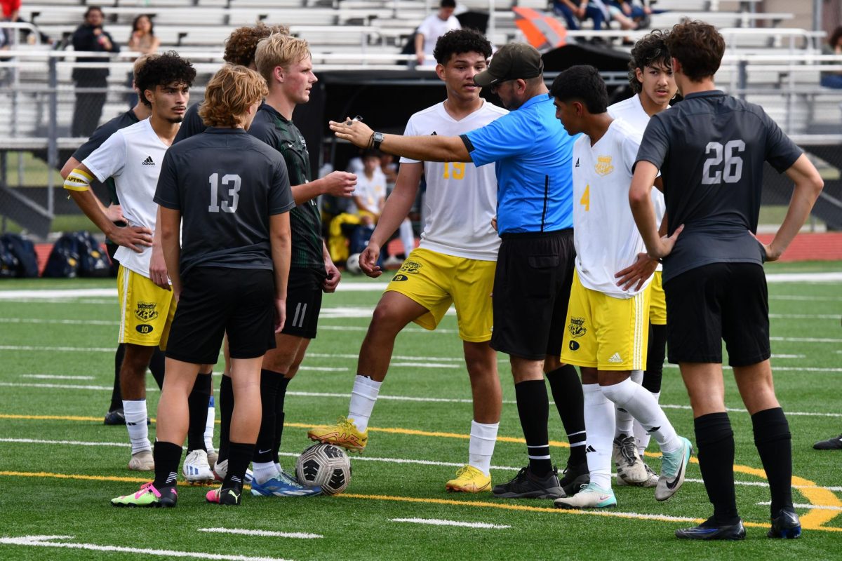 Sophomore goalkeeper Noah Laughlins teammates try to convince the ref to just issue a warning after Laughlin earned a goalkeeper penalty on the edge of the box. 