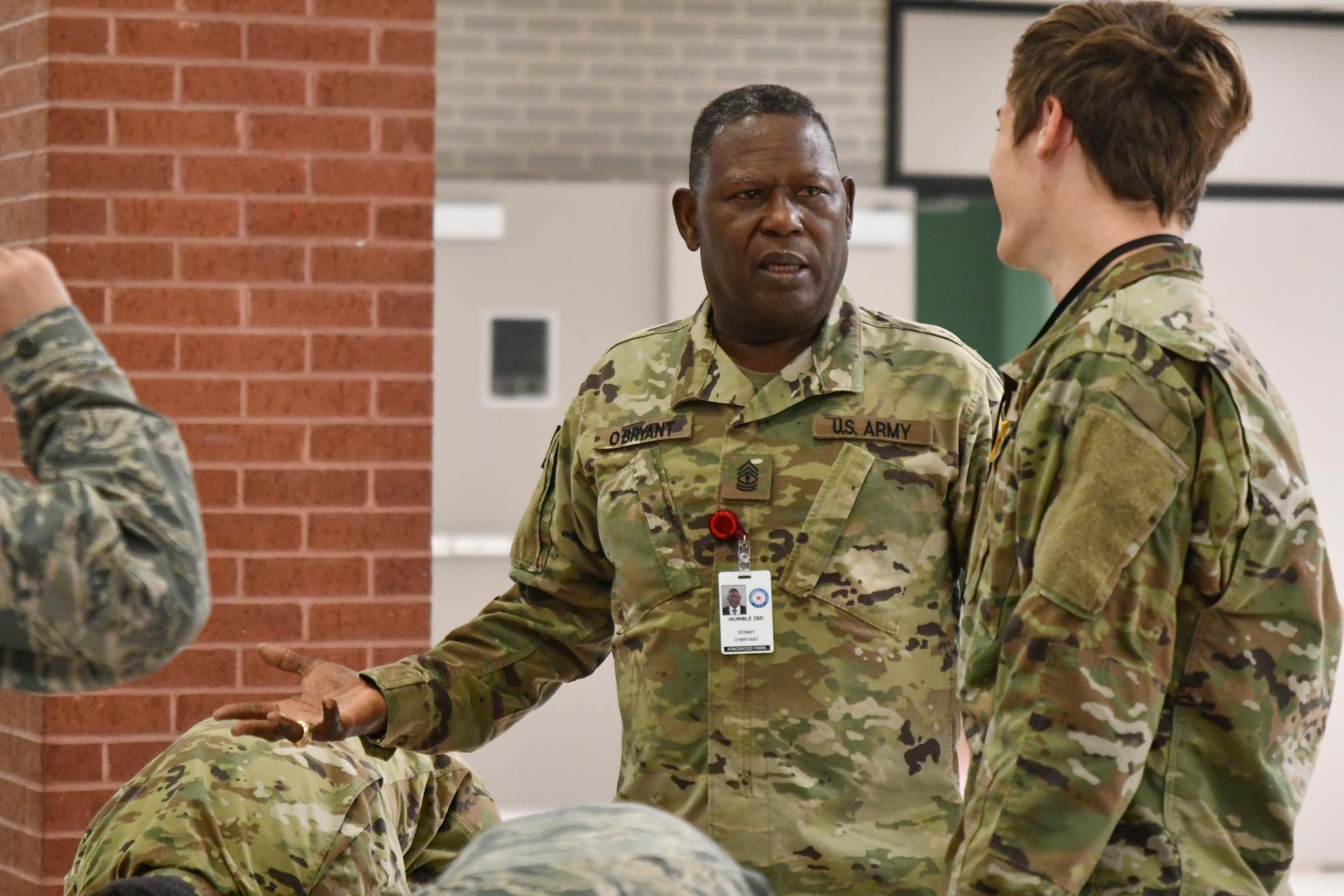 First Sergeant Donny O’Bryant talks with students as he gets them into formation in the commons before school. He spent much of his teaching career in charge of the JROTC program at Summer Creek High School. 