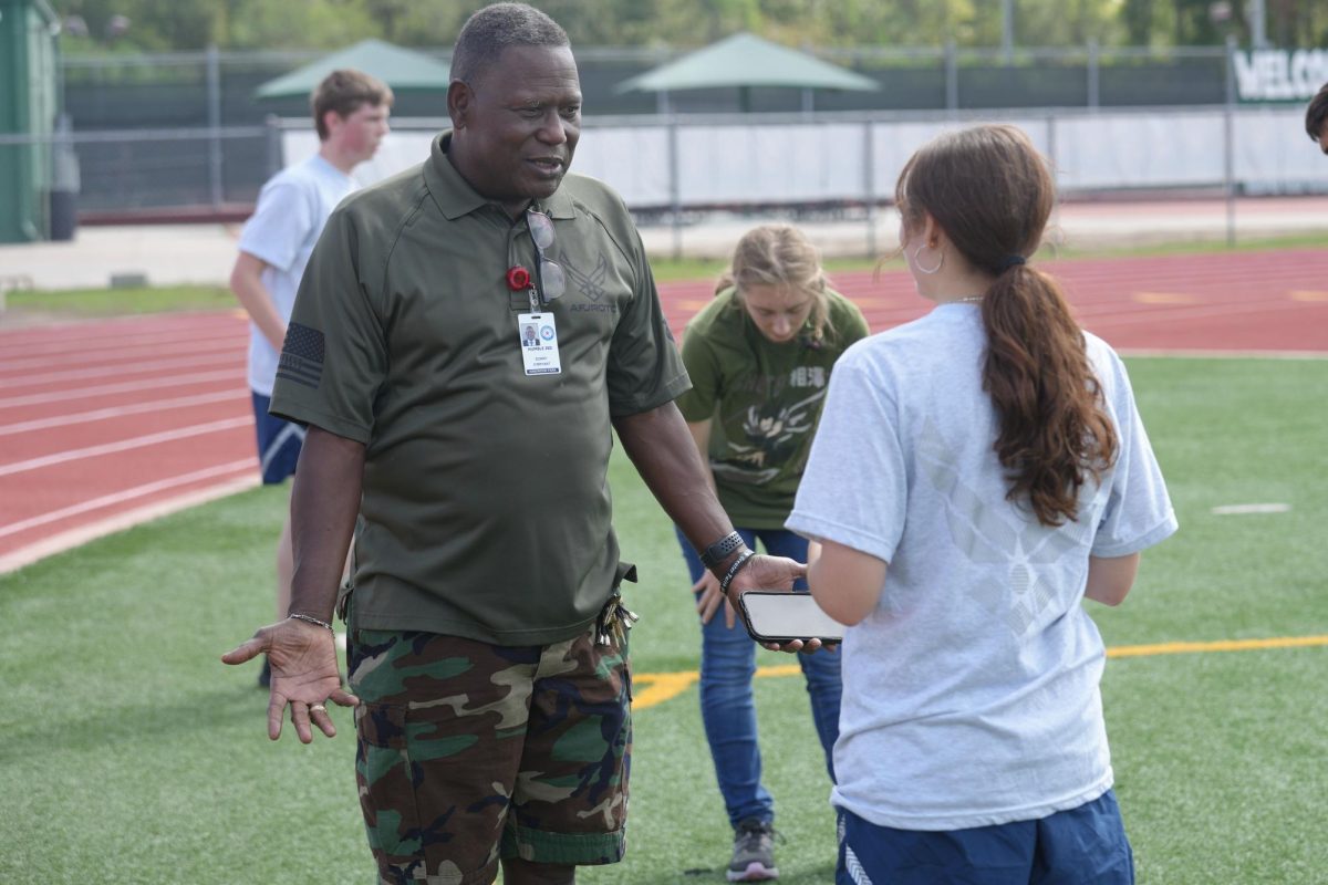 First Sergeant Donny O’Bryant talks with a student out near the track. The students spent one day each week running the track during JROTC class. He often joined them for a few of the laps. 
