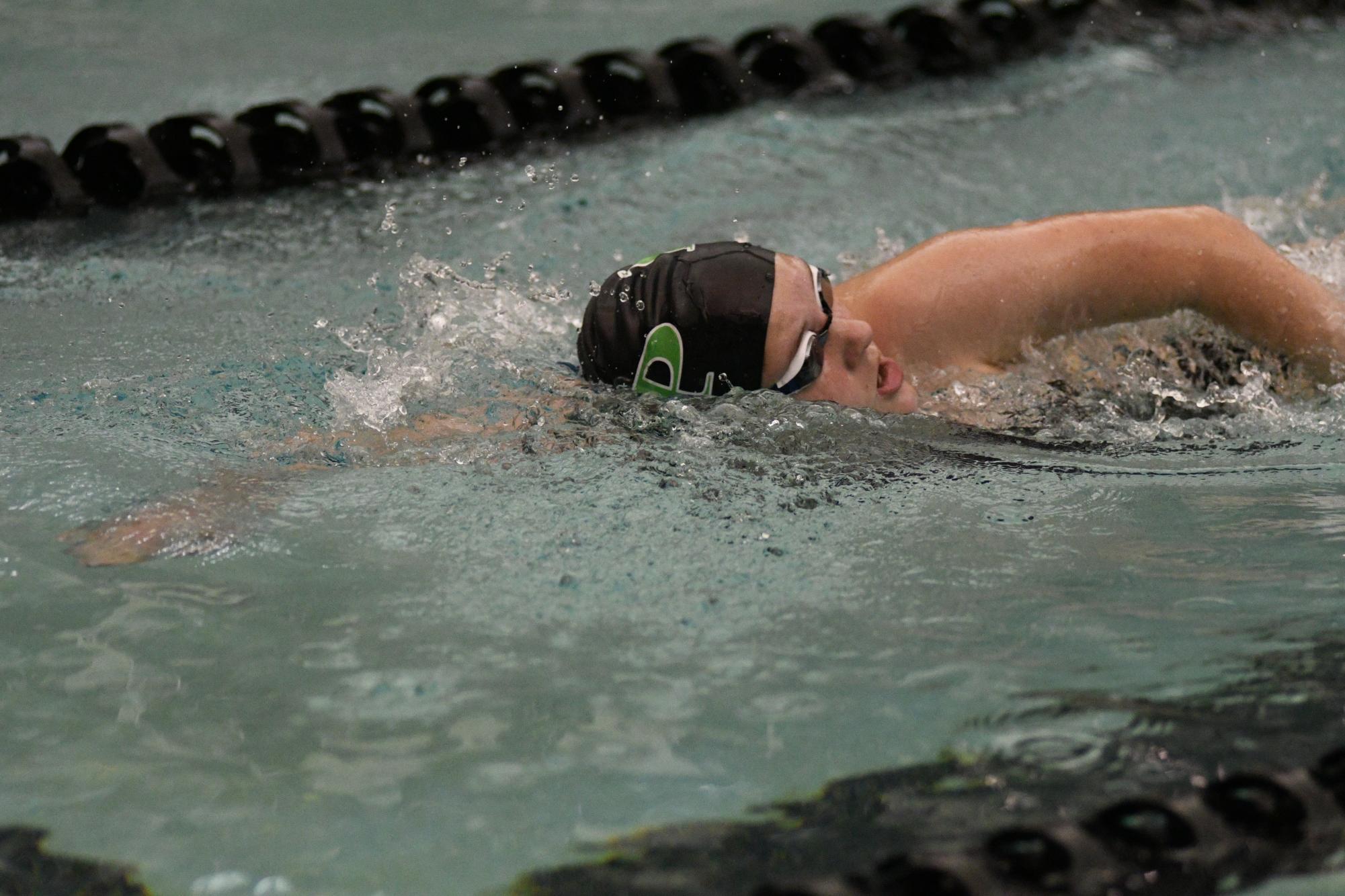 Freshman Addison Blons competes in the freestyle during the Senior Night meet on Jan. 12. During middle school, Blons had surgery on both of her knees.