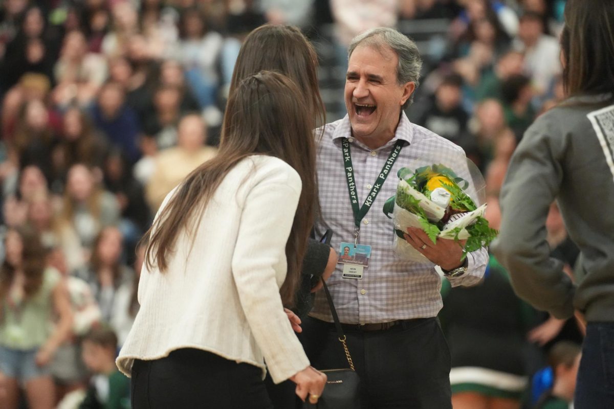 Dr. Kevin Caizley is surprised by his wife Krista and daughter Emily after being named campus Teacher of the Year at the pep rally on Jan. 26. 