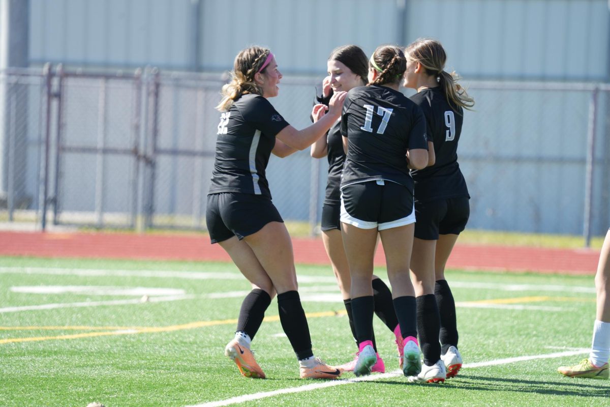 The Panthers celebrate after another goal was scored against Spring Woods. The team finished with a 4-2 win on Jan. 4. 