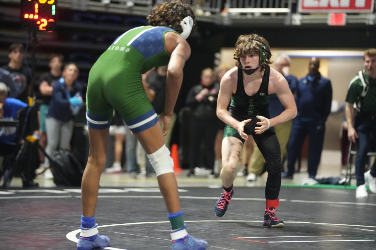 Senior Lucas Early faces off against Isaiah Mathew from Frisco Reedy High School in Early’s final match on Feb. 17 at the State Championships. Early won the match, 2-1, to secure the 5th place medal.