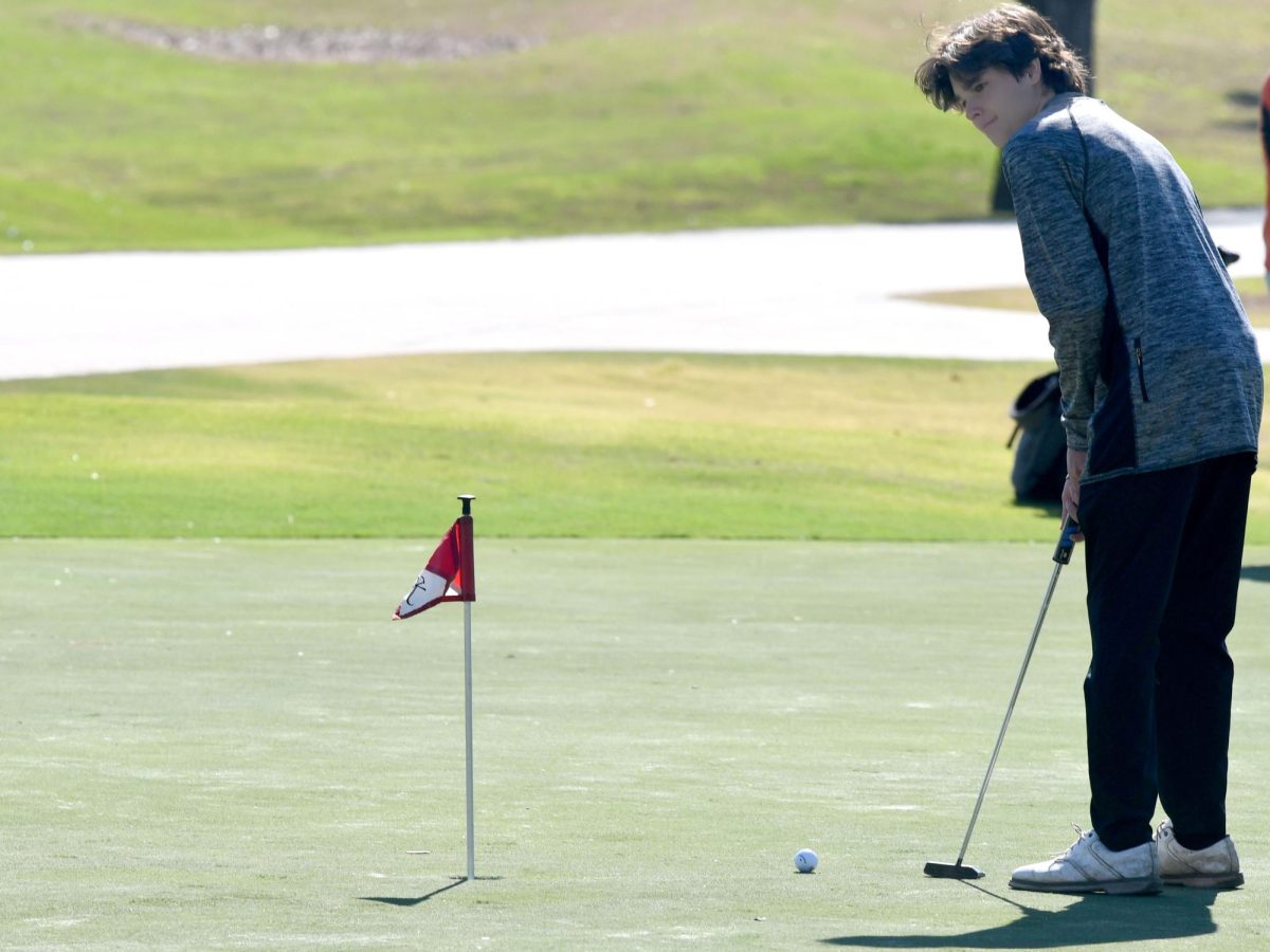 Junior Grant McTaggart putts at Kingwood Country Club on Feb. 19. 