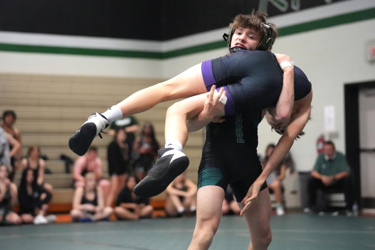 Senior Lucas Early picks up his opponent and throws him during a regular season match on Nov. 15. 